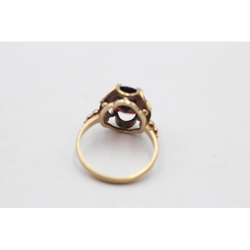 12 - A hallmarked Birmingham 9ct gold garnet dress ring, size H½ - approx. gross weight 2.1 grams