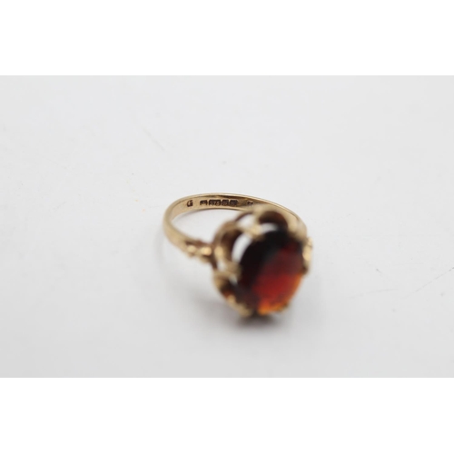 12 - A hallmarked Birmingham 9ct gold garnet dress ring, size H½ - approx. gross weight 2.1 grams