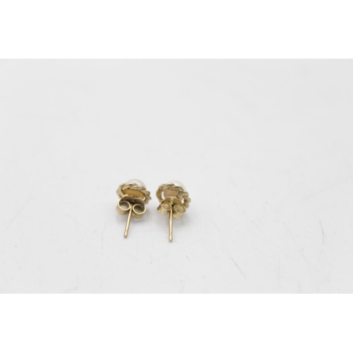 121 - Two pairs of 9ct gold pearl paired earrings, one stud and one drop - approx. gross weight 2.3 grams