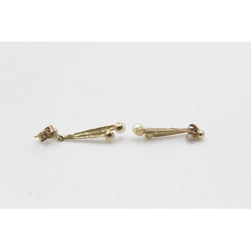 121 - Two pairs of 9ct gold pearl paired earrings, one stud and one drop - approx. gross weight 2.3 grams