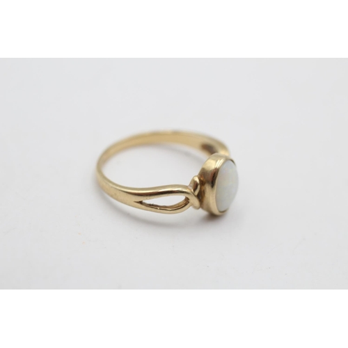 14 - A 9ct gold opal twist ring, size N½ - approx gross weight 2.1 grams