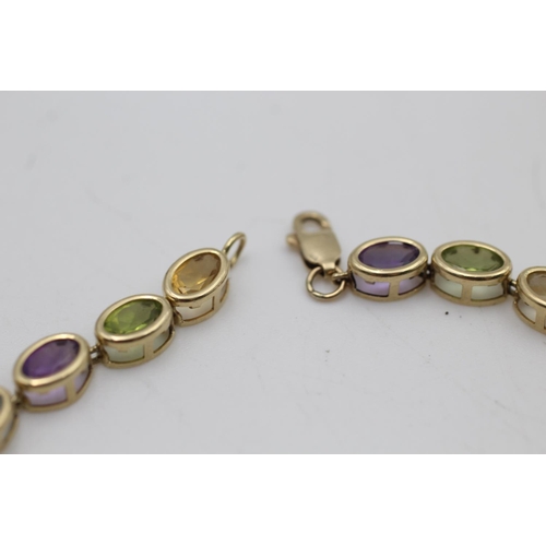 147 - A 10ct gold amethyst, peridot, citrine and topaz bracelet - approx. gross weight 6.1 grams