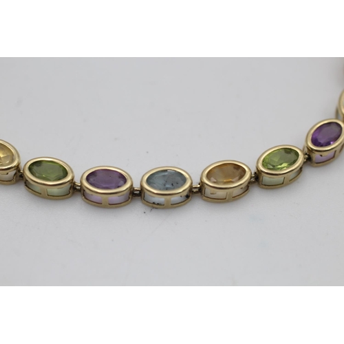 147 - A 10ct gold amethyst, peridot, citrine and topaz bracelet - approx. gross weight 6.1 grams