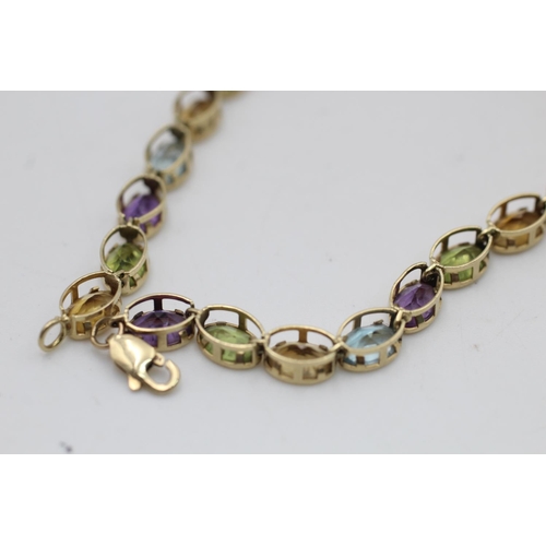 147 - A 10ct gold amethyst, peridot, citrine and topaz bracelet - approx. gross weight 6.1 grams