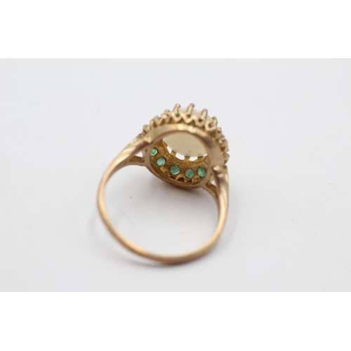 169 - A hallmarked London 9ct gold opal and emerald halo cocktail ring, size Q½ - approx. gross weight 4.2... 