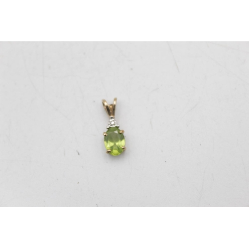 22 - A 9ct gold peridot stud earrings and pendant set - approx. gross weight 1.7 grams