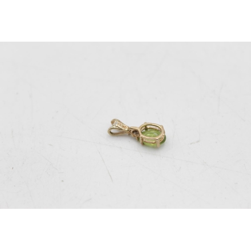 22 - A 9ct gold peridot stud earrings and pendant set - approx. gross weight 1.7 grams