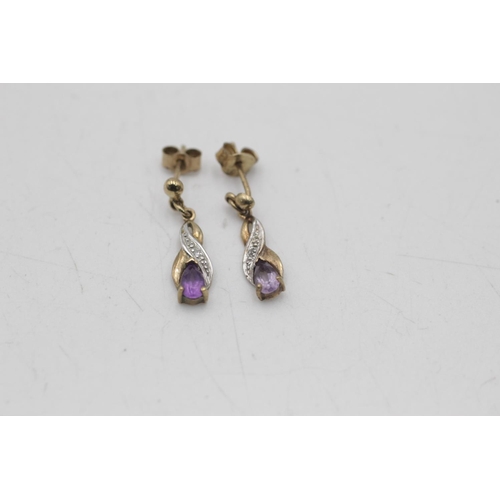 26 - Two pairs of 9ct gold gemstone and diamond infinity knot drop earrings, one ruby and one amethyst - ... 