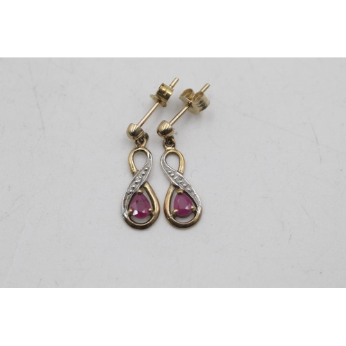 26 - Two pairs of 9ct gold gemstone and diamond infinity knot drop earrings, one ruby and one amethyst - ... 