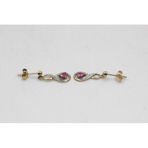 26 - Two pairs of 9ct gold gemstone and diamond infinity knot drop earrings, one ruby and one amethyst - ... 