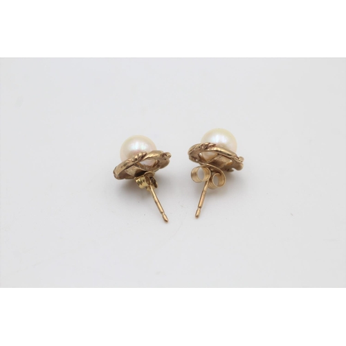 37 - A pair of 9ct gold cultured pearl stud earrings - approx. gross weight 2.3 grams