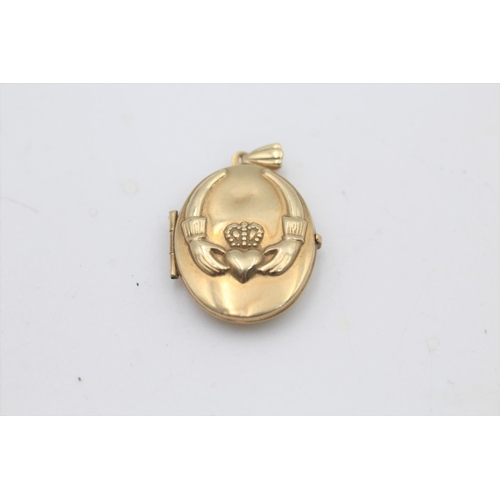 53 - A 9ct gold claddagh design locket pendant - approx. gross weight 1.8 grams