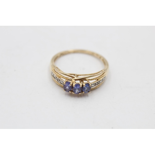 54 - A 14ct gold tanzanite diamond shoulder three stone ring, size P½ - approx. gross weight 2.4 grams