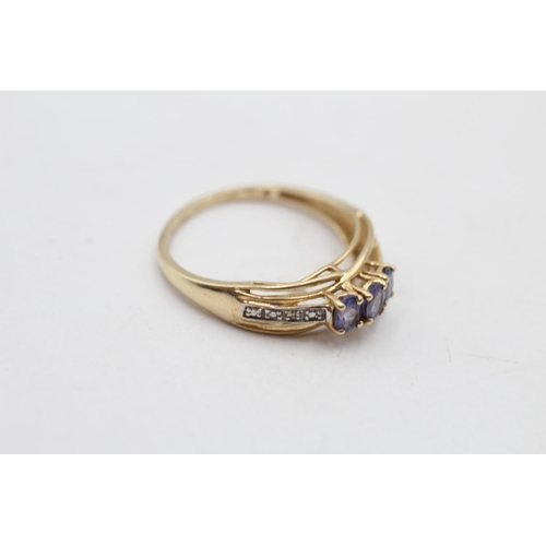 54 - A 14ct gold tanzanite diamond shoulder three stone ring, size P½ - approx. gross weight 2.4 grams