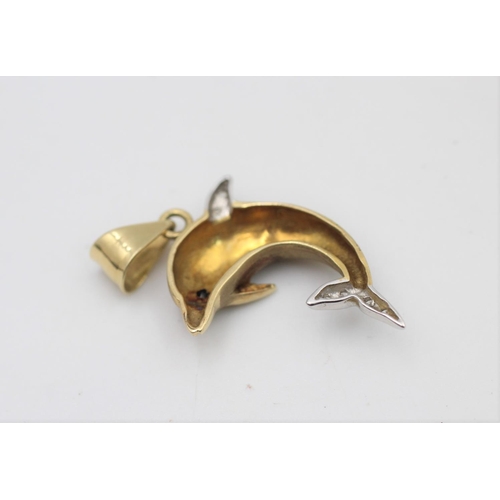 58 - A 14ct gold clear gemstone and sapphire set dolphin pendant - approx. gross weight 4 grams