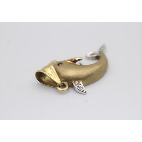 58 - A 14ct gold clear gemstone and sapphire set dolphin pendant - approx. gross weight 4 grams