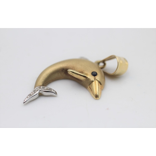 58 - A 14ct gold clear gemstone and sapphire set dolphin pendant - approx. gross weight 4 grams