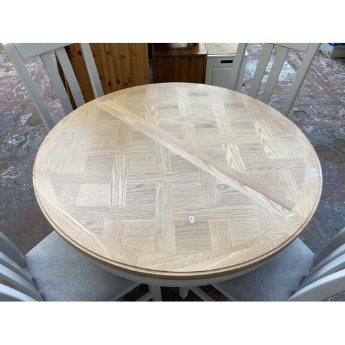 1019 - A contemporary oak and grey finish circular extending pedestal dining table with four matching dinin... 