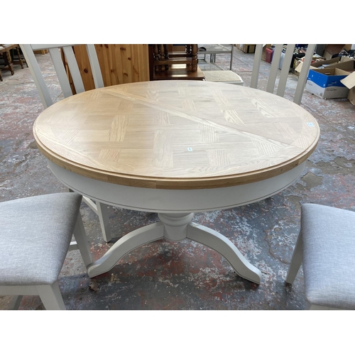 1019 - A contemporary oak and grey finish circular extending pedestal dining table with four matching dinin... 