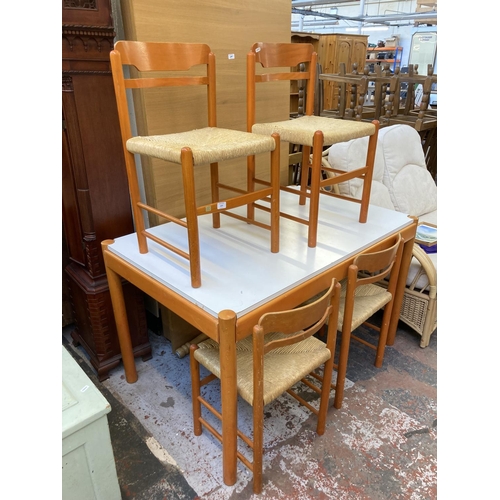 1042 - A mid 20th century rectangular dining table with white laminate top, orange finish and four matching... 