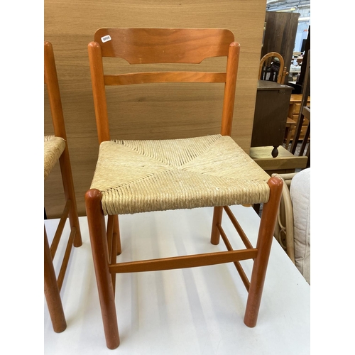 1042 - A mid 20th century rectangular dining table with white laminate top, orange finish and four matching... 