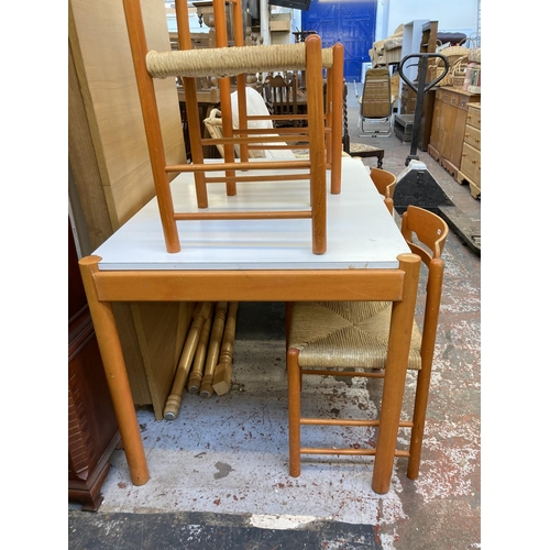 1042 - A mid 20th century rectangular dining table with white laminate top, orange finish and four matching... 