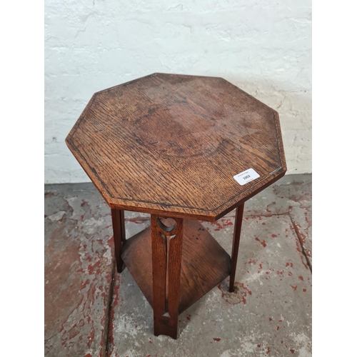 1003 - An Arts and Crafts inlaid oak octagonal top two tier side table - approx. 68cm high x 36cm wide x 38... 