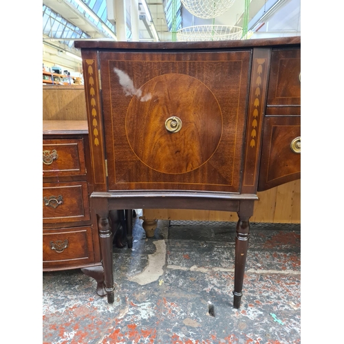 1007 - A George IV style mahogany serpentine sideboard with two central drawers, two outer cupboard doors a... 