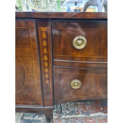 1007 - A George IV style mahogany serpentine sideboard with two central drawers, two outer cupboard doors a... 