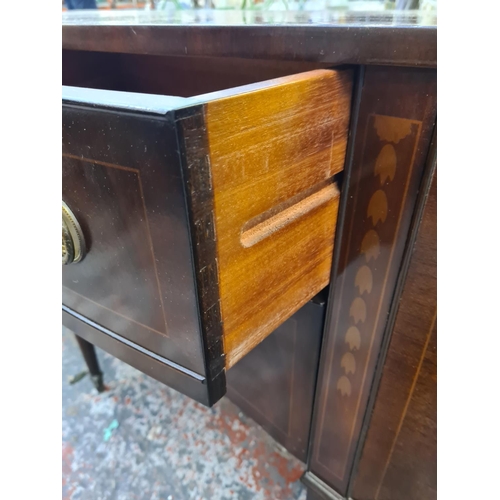 1007 - A George IV style mahogany serpentine sideboard with two central drawers, two outer cupboard doors a... 