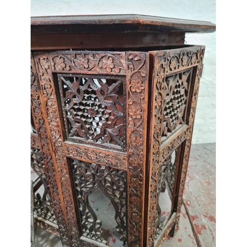 1037 - An Indian heavily carved teak octagonal top side table