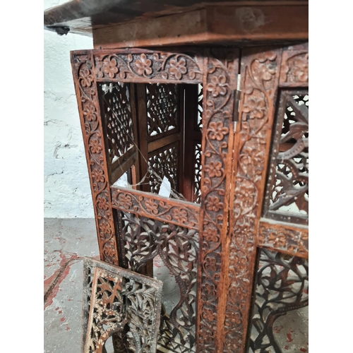 1037 - An Indian heavily carved teak octagonal top side table