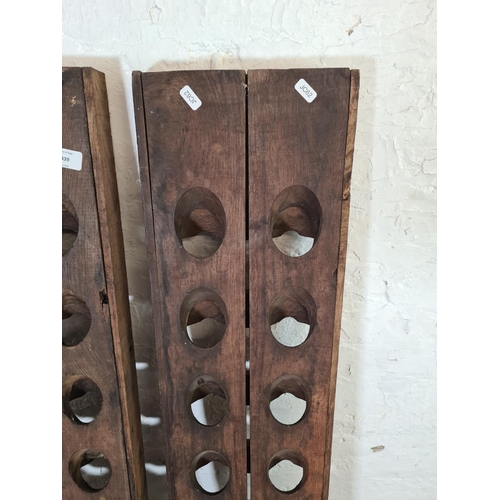 1039 - A pair of vintage reclaimed wood twenty bottle wine racks, one monogrammed 