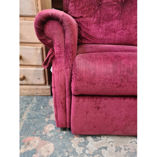 1047 - A modern burgundy upholstered electric reclining armchair with remote and owners manual