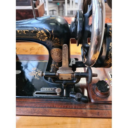 1055 - A vintage Pfaff treadle sewing machine with lid and table