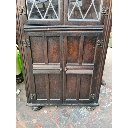 1056 - An oak freestanding corner cabinet - approx. 167cm high x 65cm wide x 33cm deep