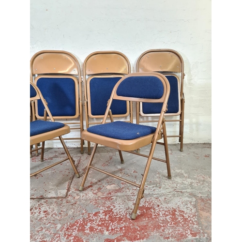 1062 - Six Sandler brown metal and blue upholstered folding chairs