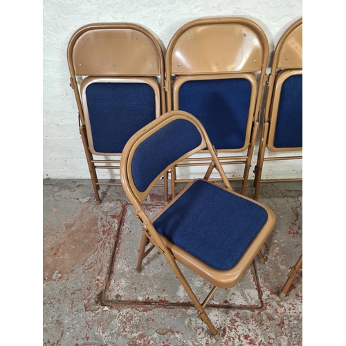 1062 - Six Sandler brown metal and blue upholstered folding chairs