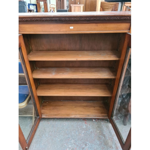 1063 - An Edwardian mahogany two door display cabinet - approx. 130cm high x 112cm wide x 32cm deep