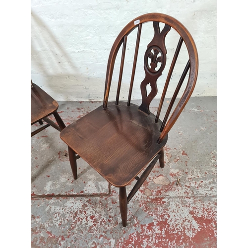 1073 - A pair of Ercol Fleur De Lys elm and beech dining chairs