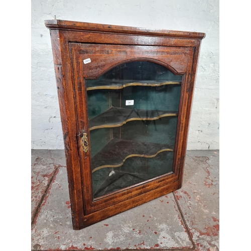 1085 - A George III oak wall hanging corner cabinet - approx. 85cm high x 67cm wide x 31cm deep