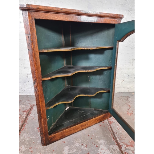 1085 - A George III oak wall hanging corner cabinet - approx. 85cm high x 67cm wide x 31cm deep