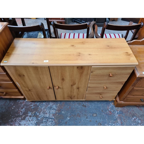 1092 - A modern pine effect sideboard - approx. 74cm high x 118cm wide x 40cm deep