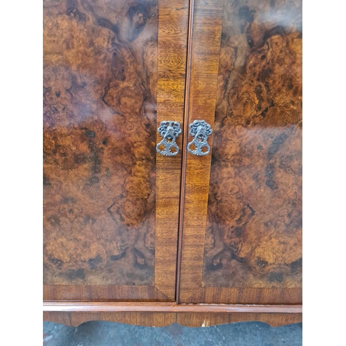 1096 - A burr walnut effect two door cabinet with cabriole supports - approx. 93cm high x 78cm wide x 46cm ... 