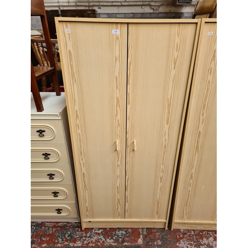 1109 - Two modern oak effect double wardrobes - approx. 161cm high x 74cm wide x 50cm deep