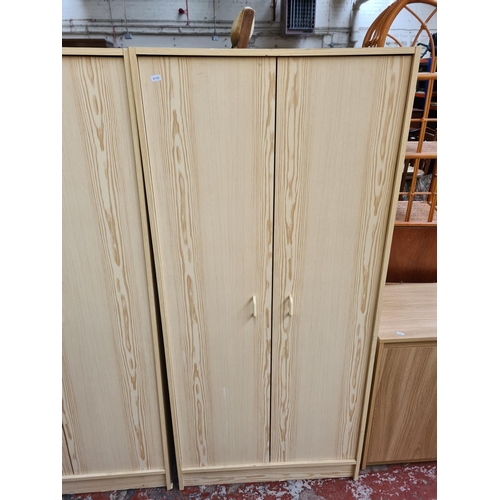 1109 - Two modern oak effect double wardrobes - approx. 161cm high x 74cm wide x 50cm deep