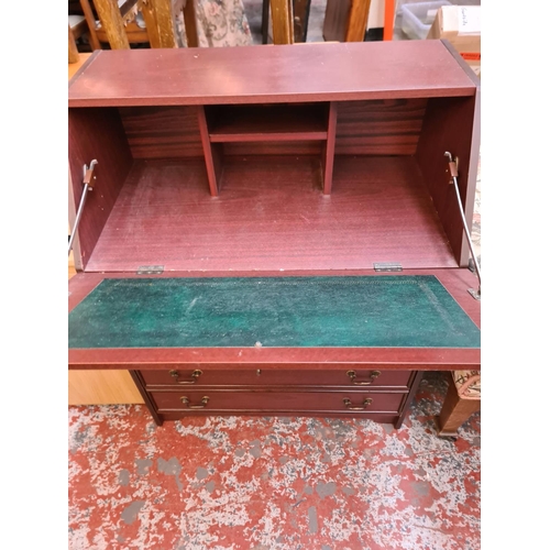 1112 - A mahogany effect bureau with four drawers and fall front - approx. 96cm high x 76cm wide x 43cm dee... 