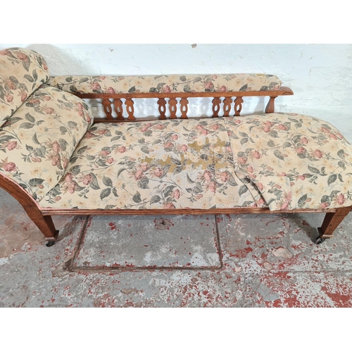 1113 - An Edwardian oak and floral upholstered chaise longue - approx. 84cm high x 67cm wide x 175cm long