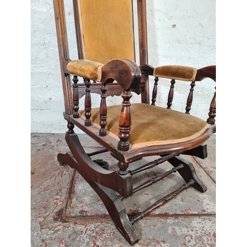 1118 - An Edwardian mahogany and yellow upholstered rocking chair