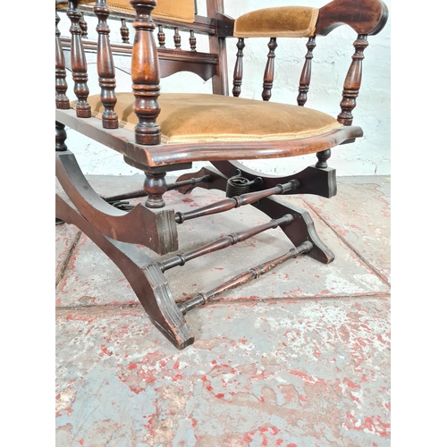 1118 - An Edwardian mahogany and yellow upholstered rocking chair